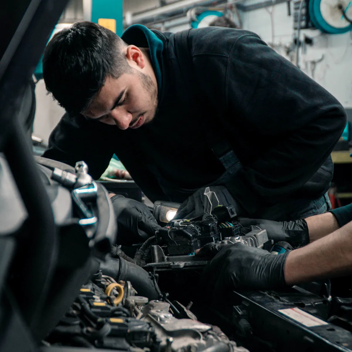 Technician working on truck engine